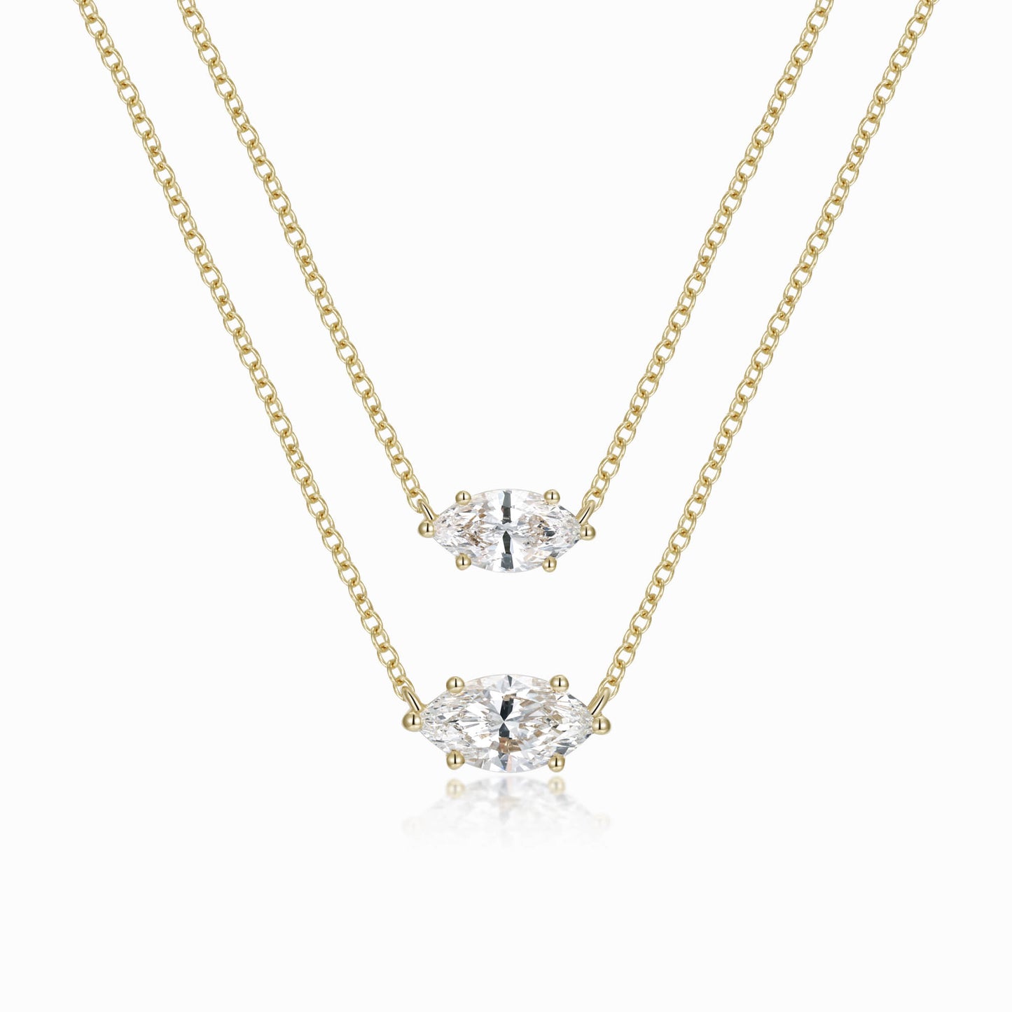 two pieces of gold chain with a diamond pendant