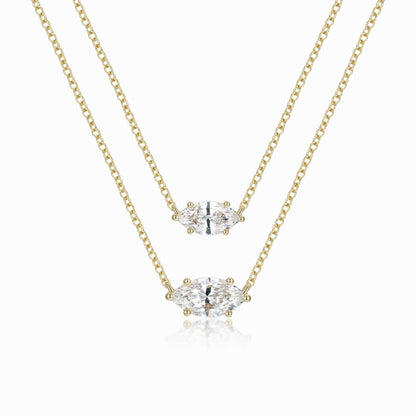 two pieces of chain with a diamond pendant