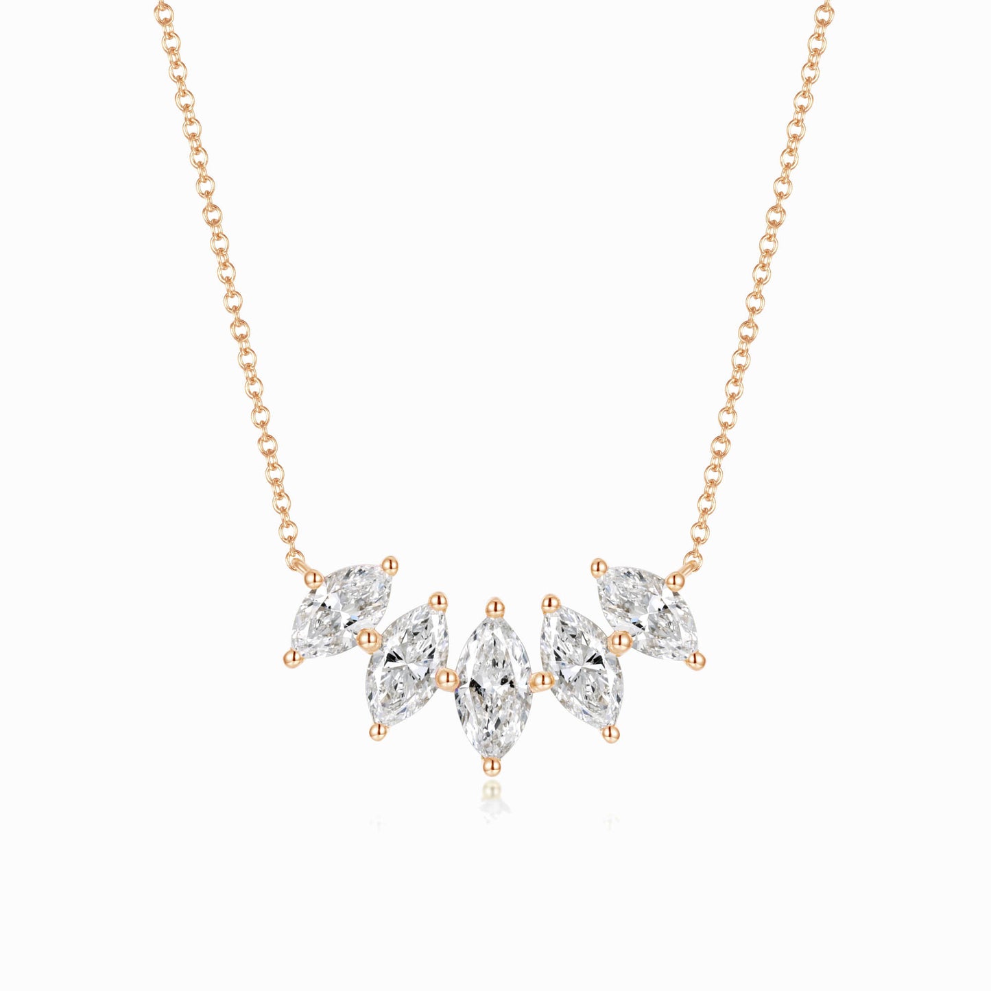 a gold necklace with three pear shaped diamonds