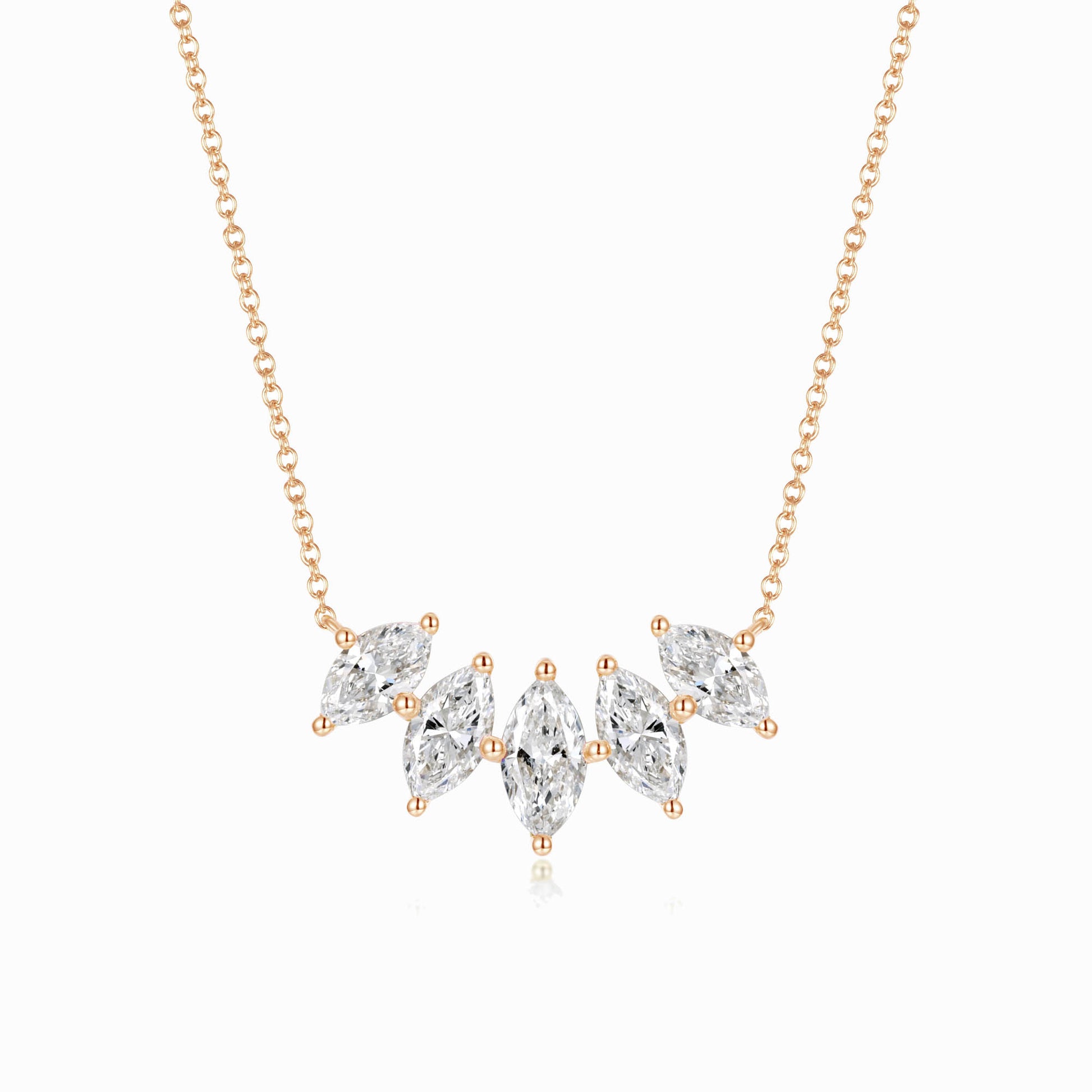 a gold necklace with three pear shaped diamonds