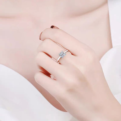 a woman wearing a ring with a diamond