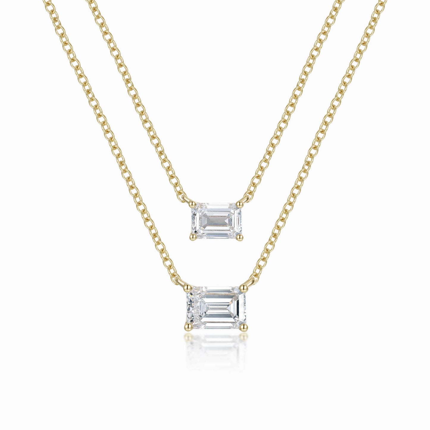 two necklaces with a baguette cut diamond