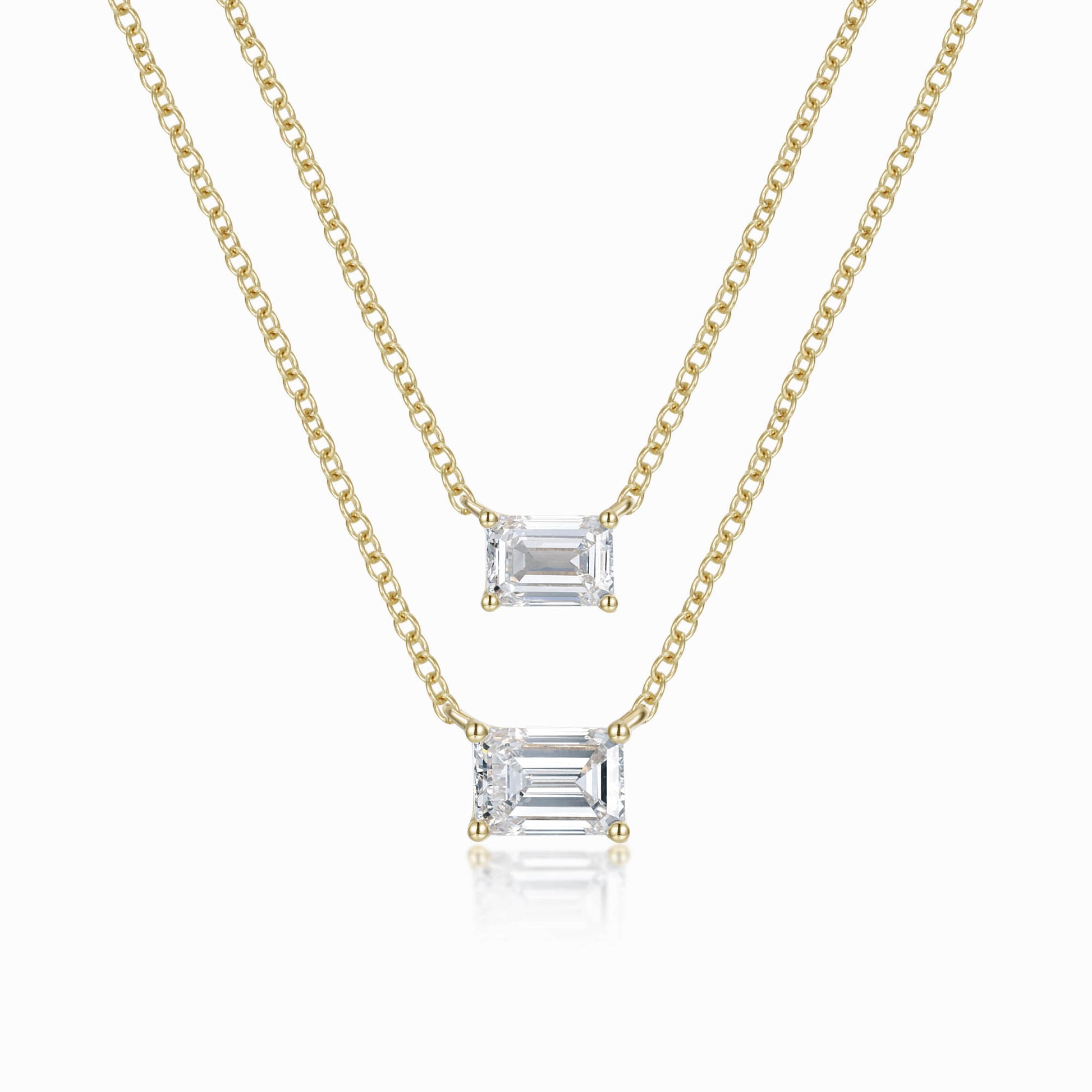 two necklaces with a baguette cut diamond