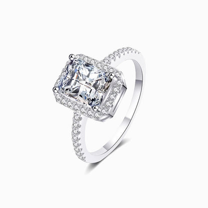a white ring with a cushion cut diamond