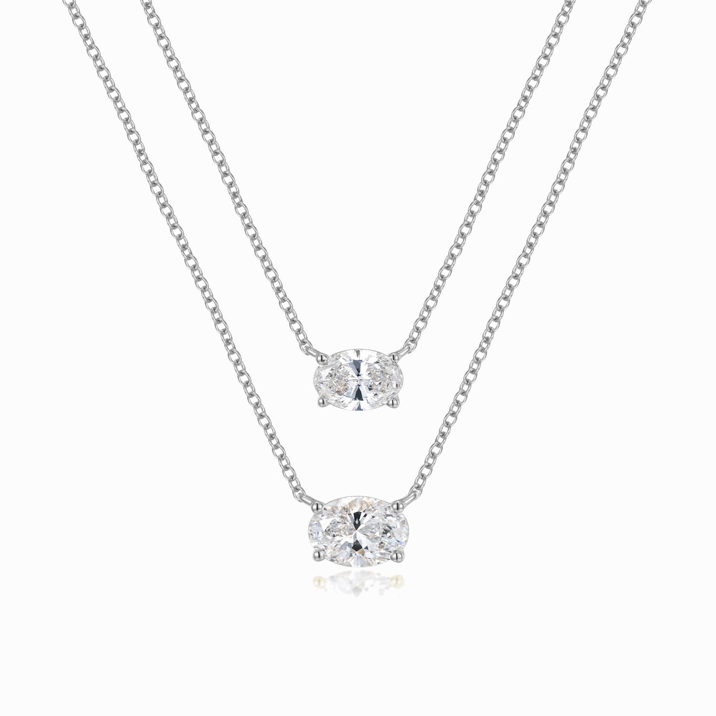 a pair of necklaces on a white background