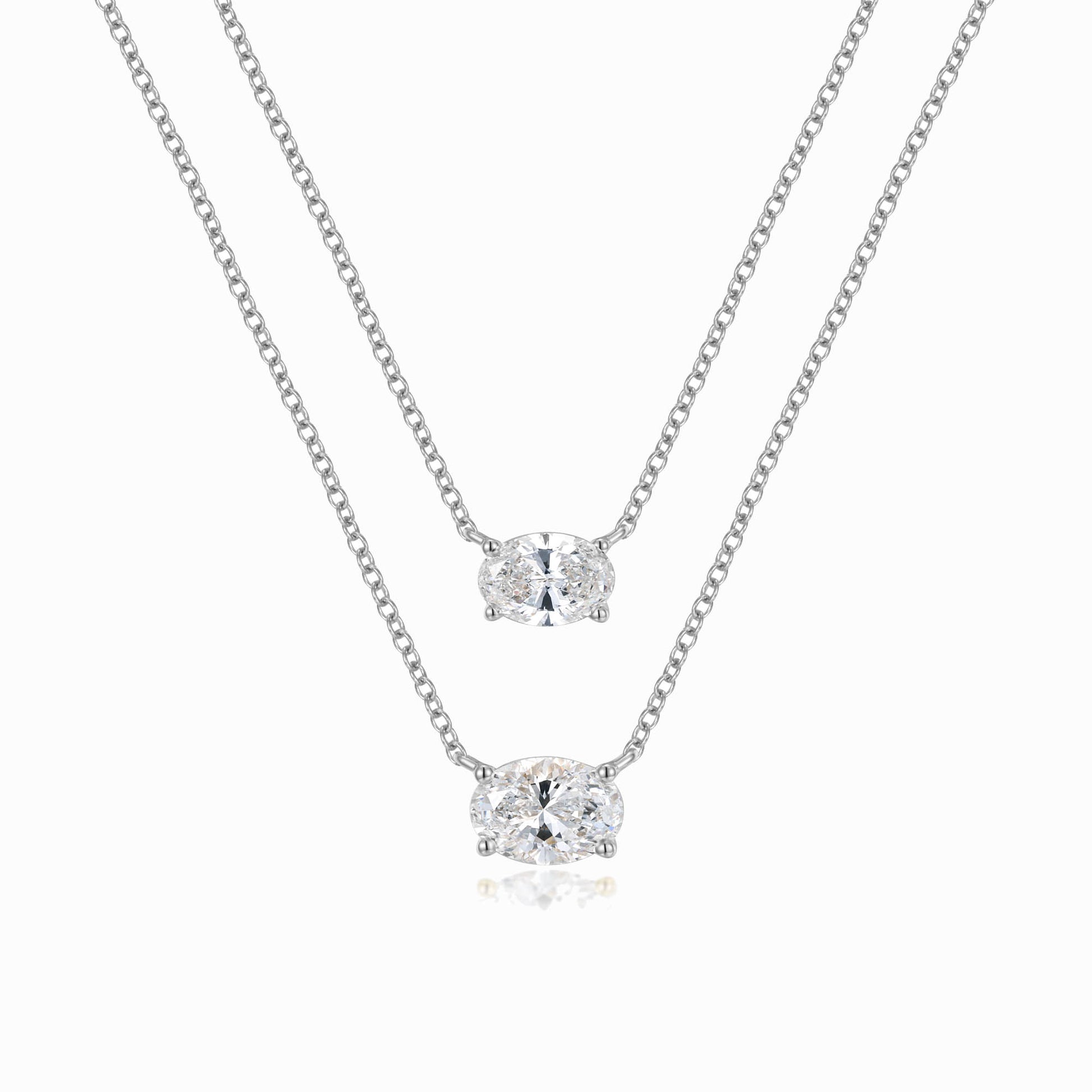 a pair of necklaces on a white background