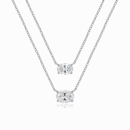 a pair of necklaces on a white background