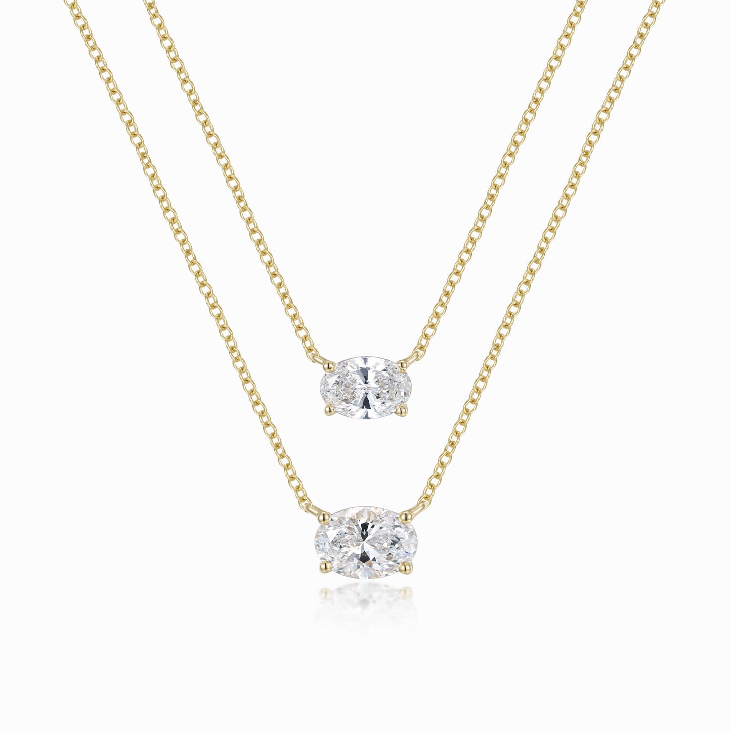 a pair of necklaces on a white background