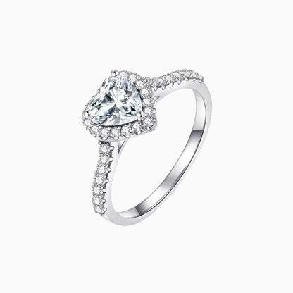 a white ring with a heart shaped diamond