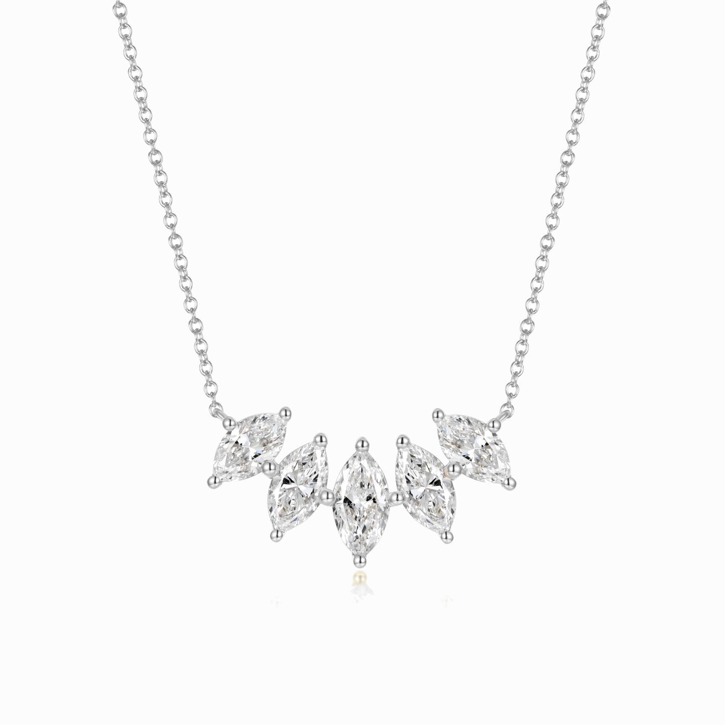 a silver necklace with three diamonds on it