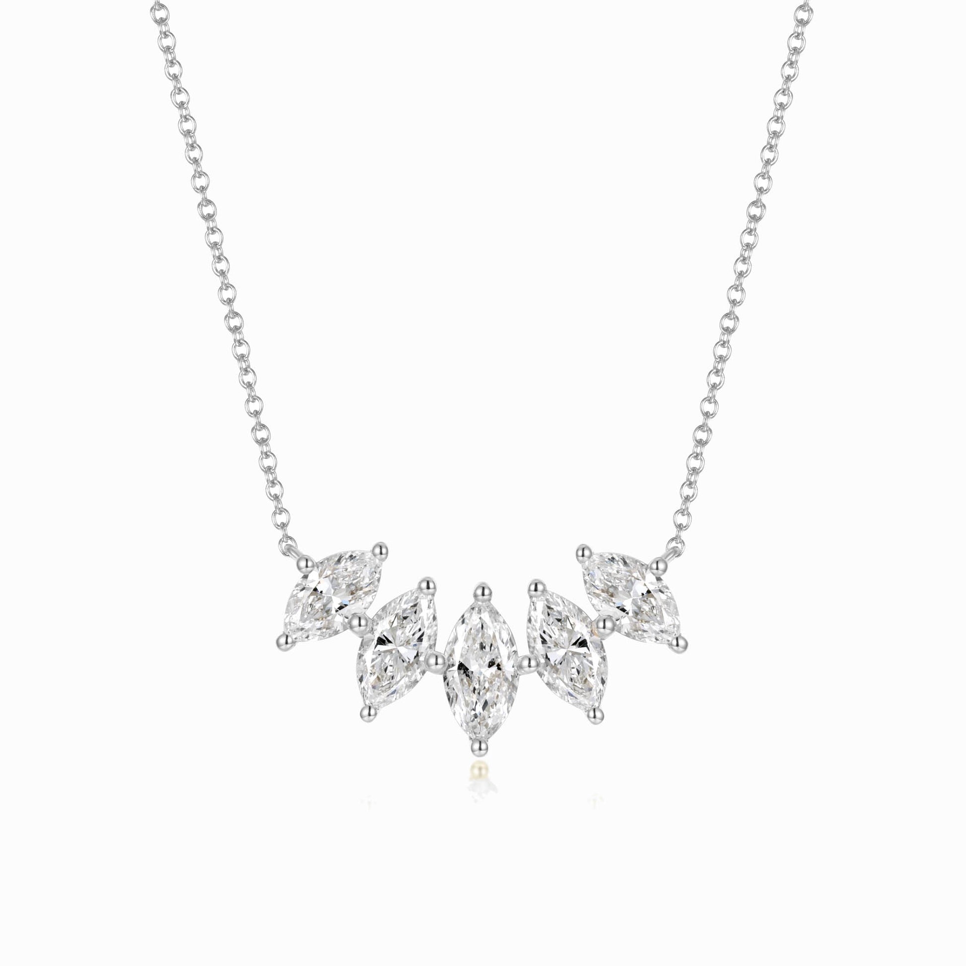 a silver necklace with three diamonds on it