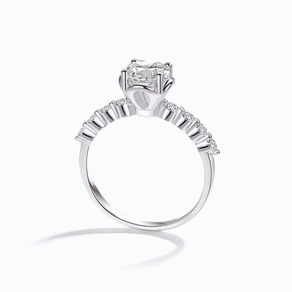 a white ring with a princess cut diamond