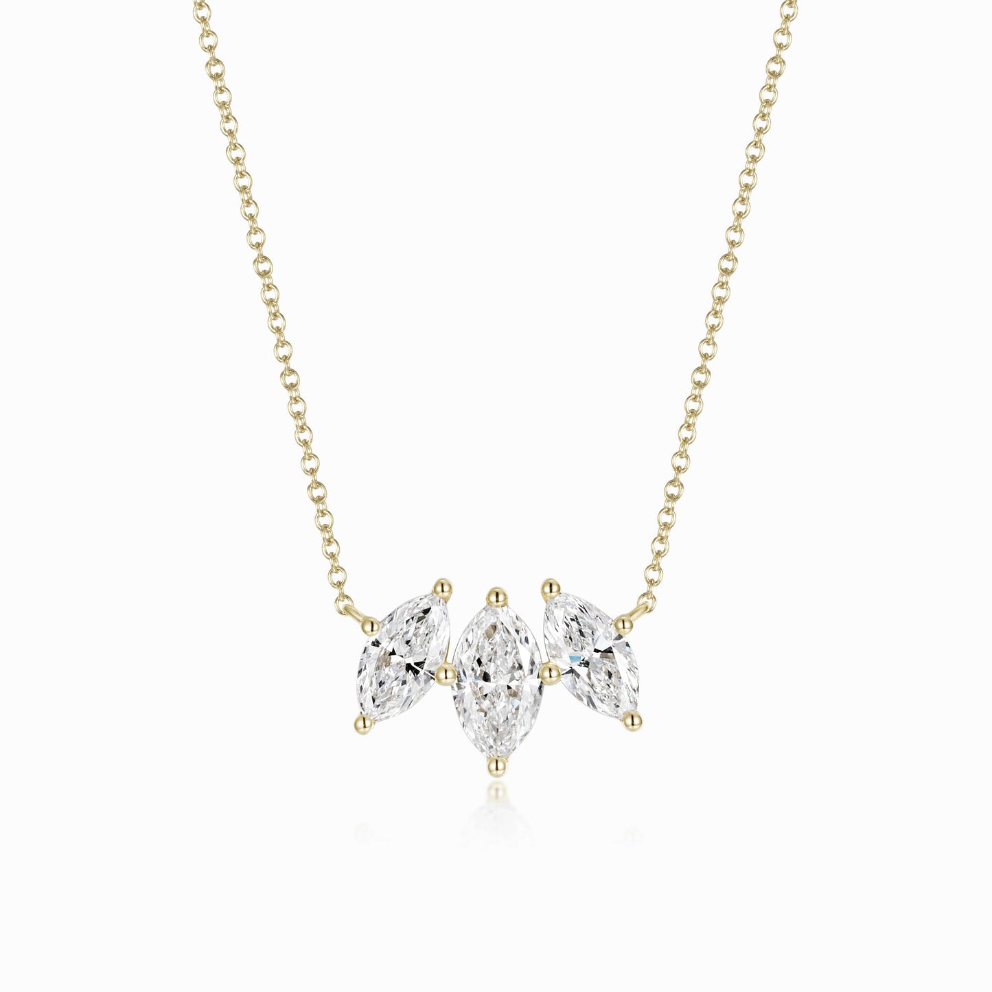 a gold necklace with three pear shaped diamonds