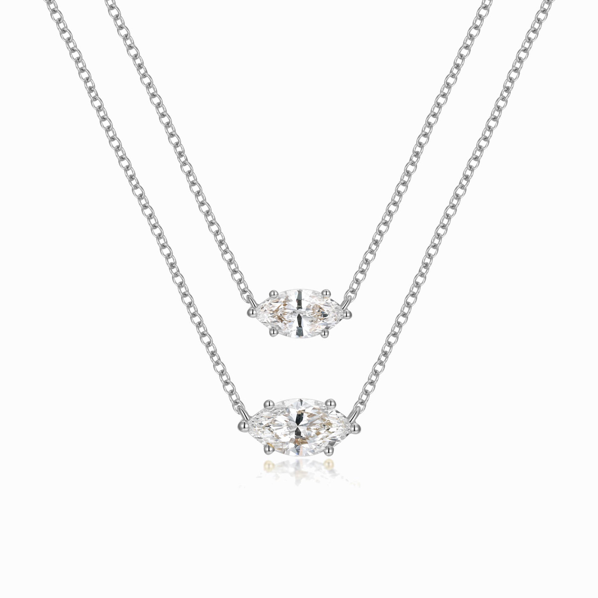 two pieces of silver necklaces on a white background