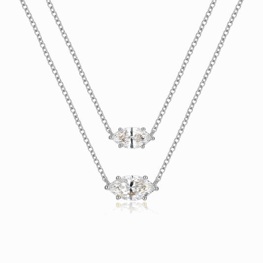 two pieces of silver necklaces on a white background