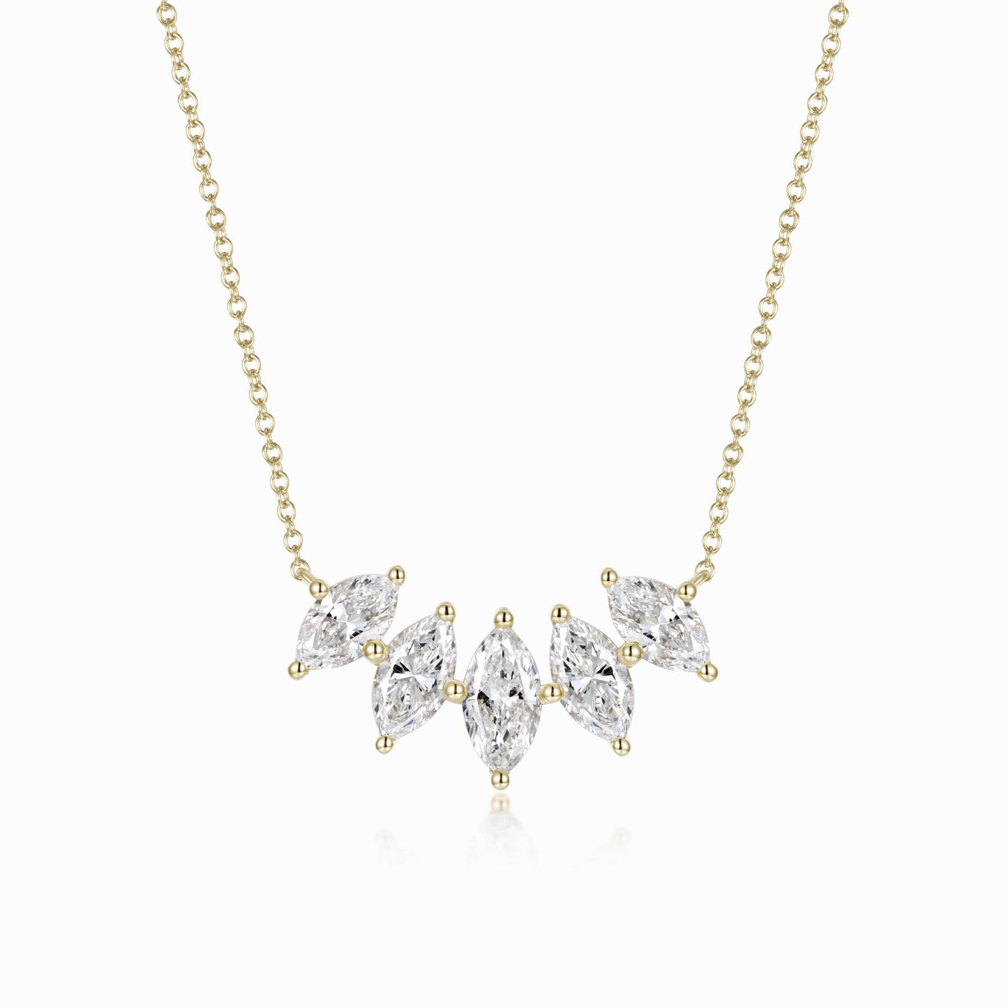 a gold necklace with three pear shaped diamonds
