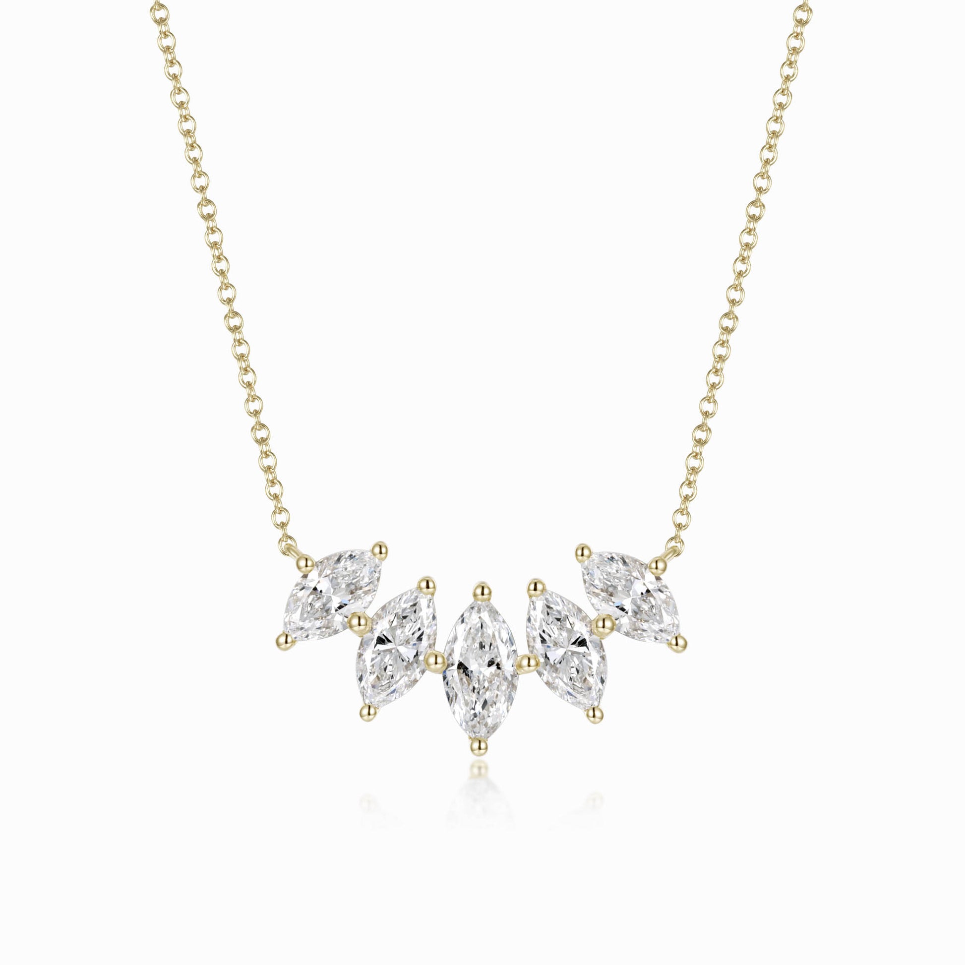 a gold necklace with three pear shaped diamonds